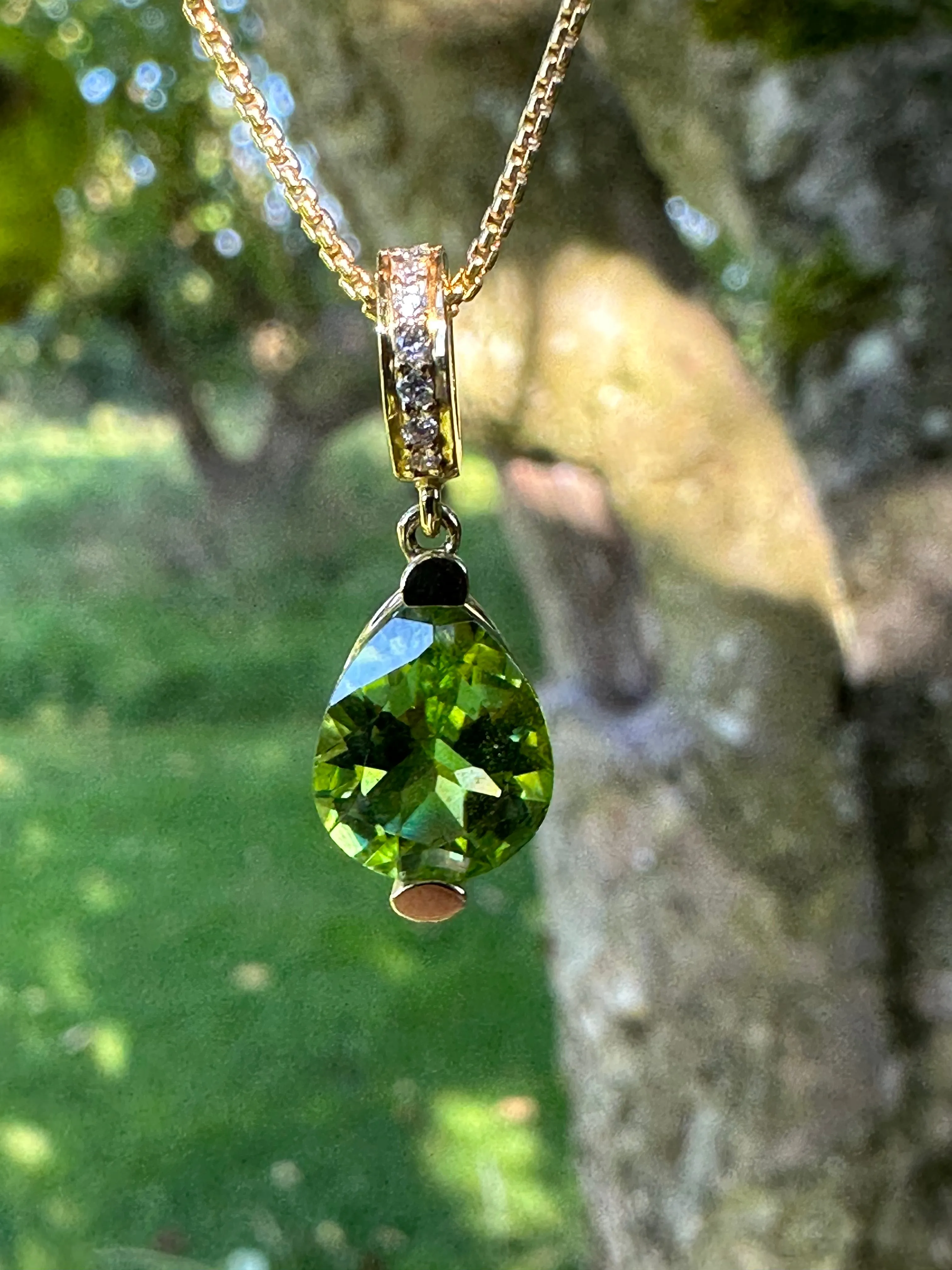 18ct Yellow gold peridot teardrop pendant with diamond set bail.