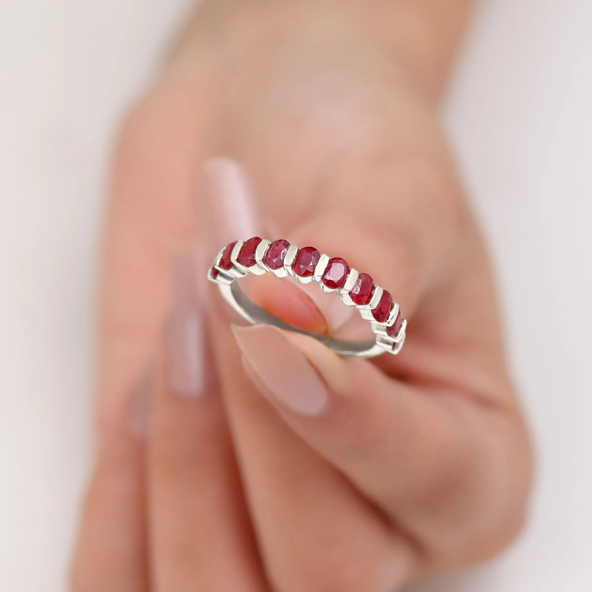 Oval Cut Created Ruby Half Eternity Ring in Bar Setting