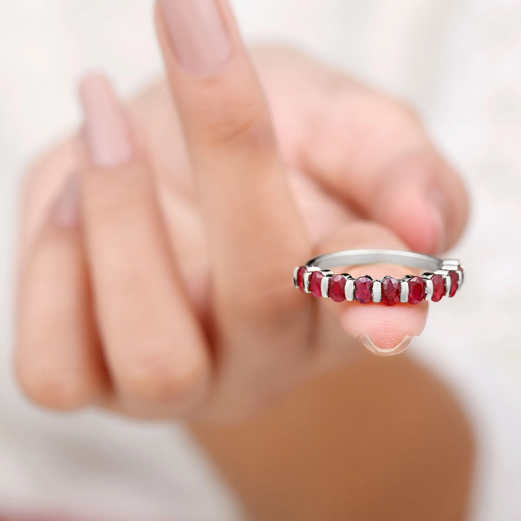 Oval Cut Created Ruby Half Eternity Ring in Bar Setting