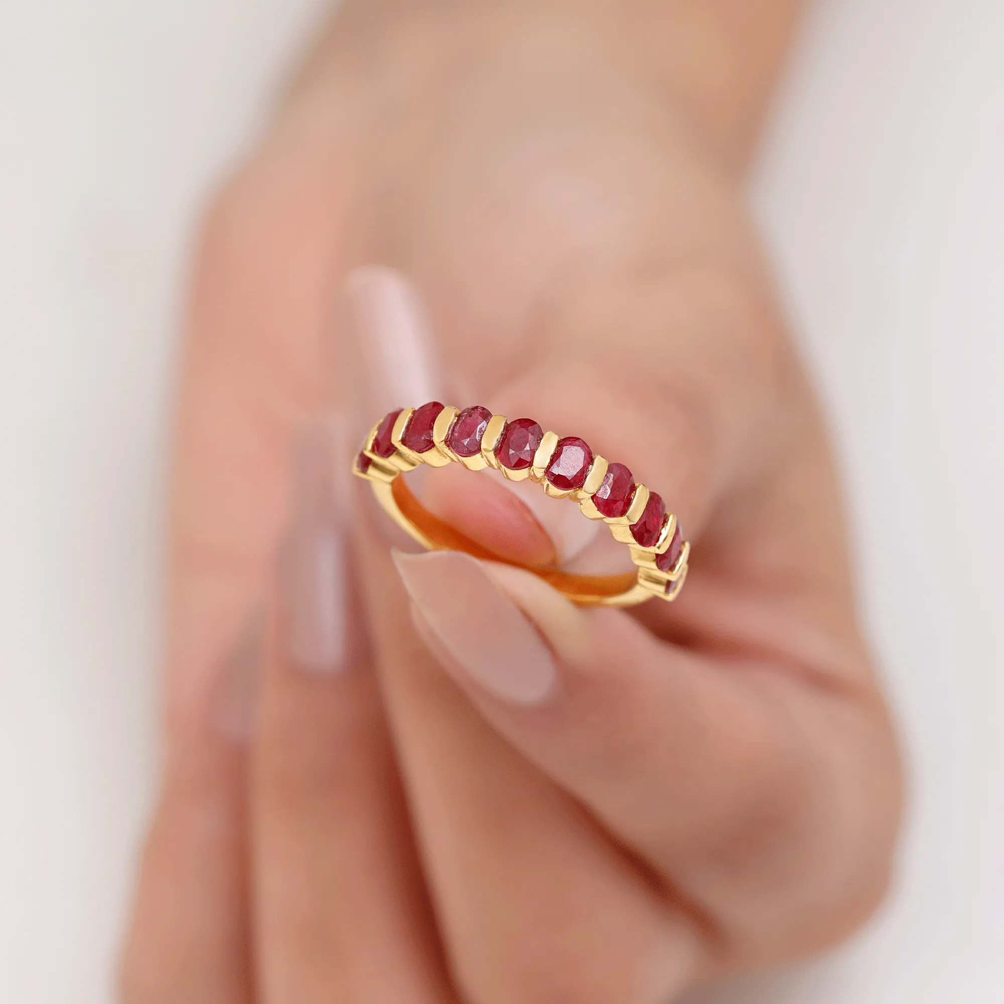 Oval Cut Created Ruby Half Eternity Ring in Bar Setting