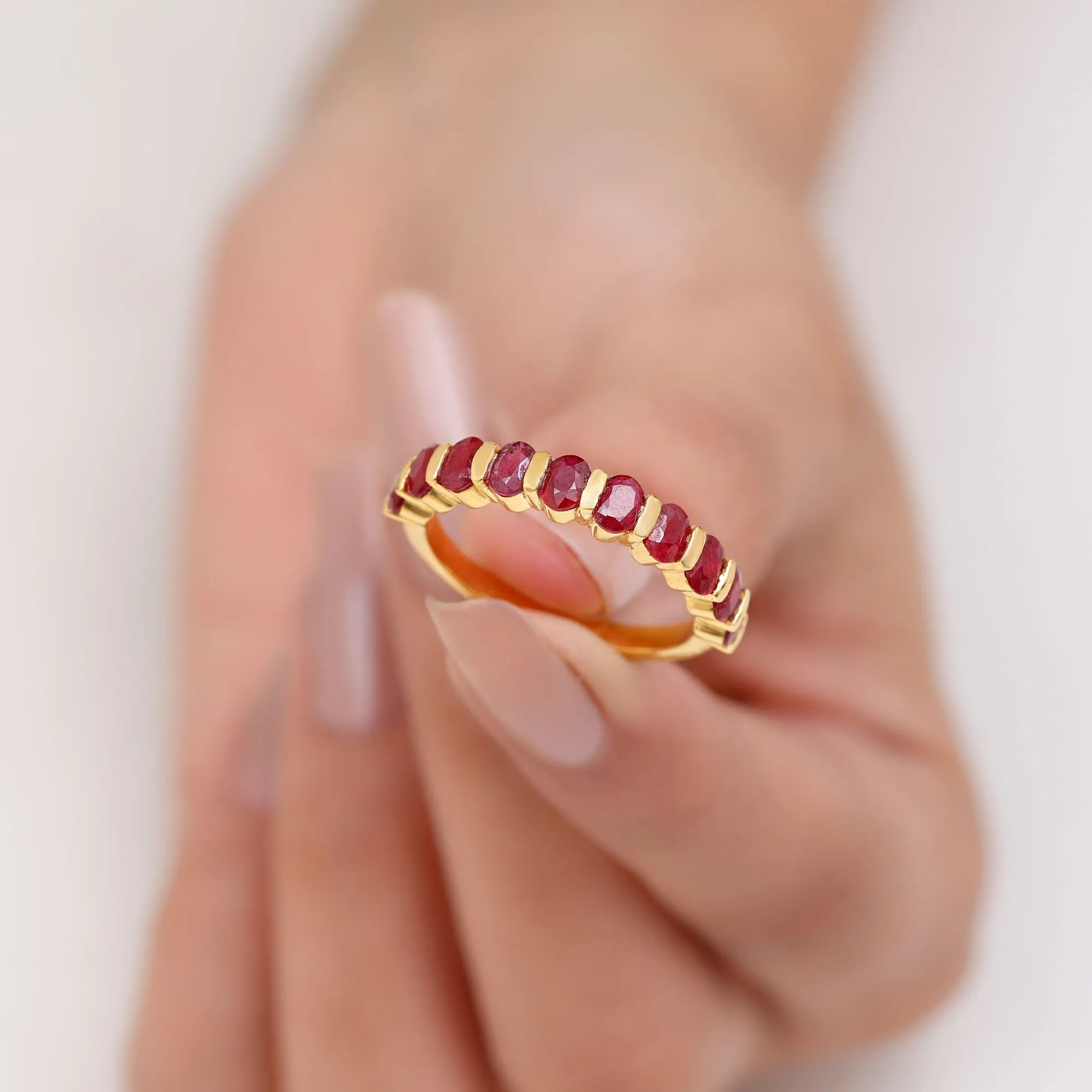 Oval Cut Created Ruby Half Eternity Ring in Bar Setting